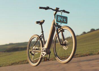 Realistic image showing an eBike battery performance indicator during a long-distance ride with scenic background