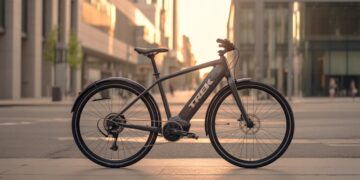 Trek Allant+ 9.9S electric bike parked on a modern city street at sunrise